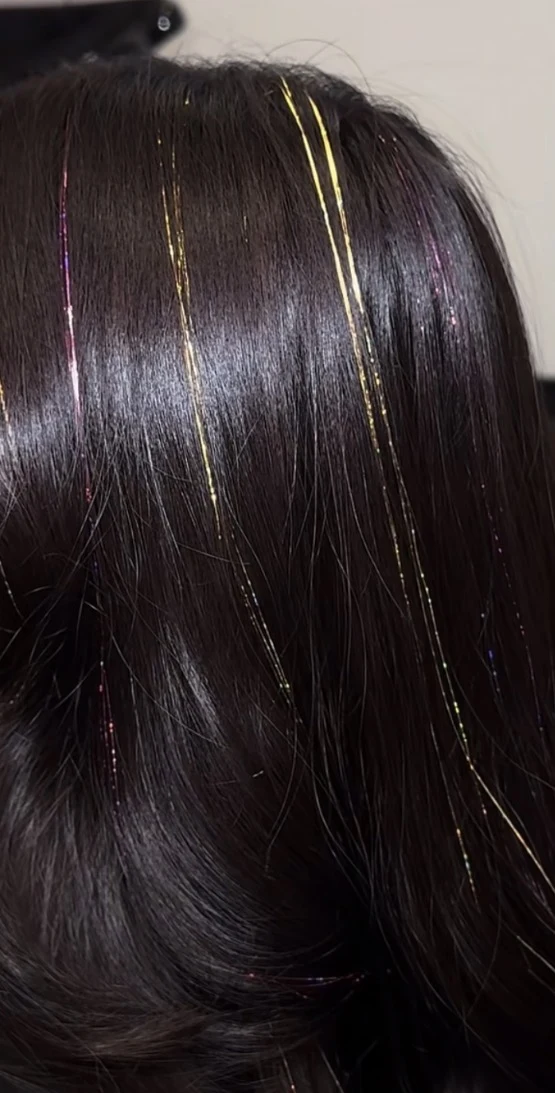Gold and pink tinsel accents in dark waves