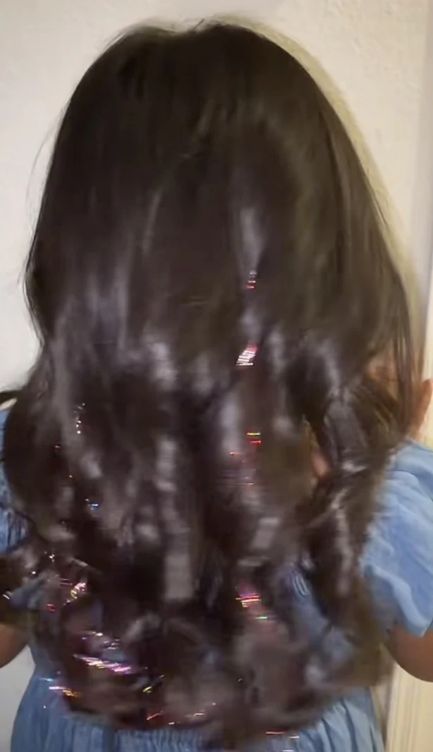 Colorful tinsel accents through dark curls