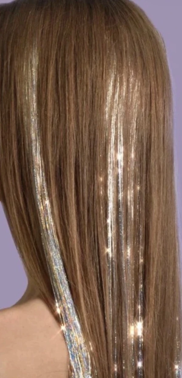 Silver iridescent tinsel shimmering through straight brunette hair