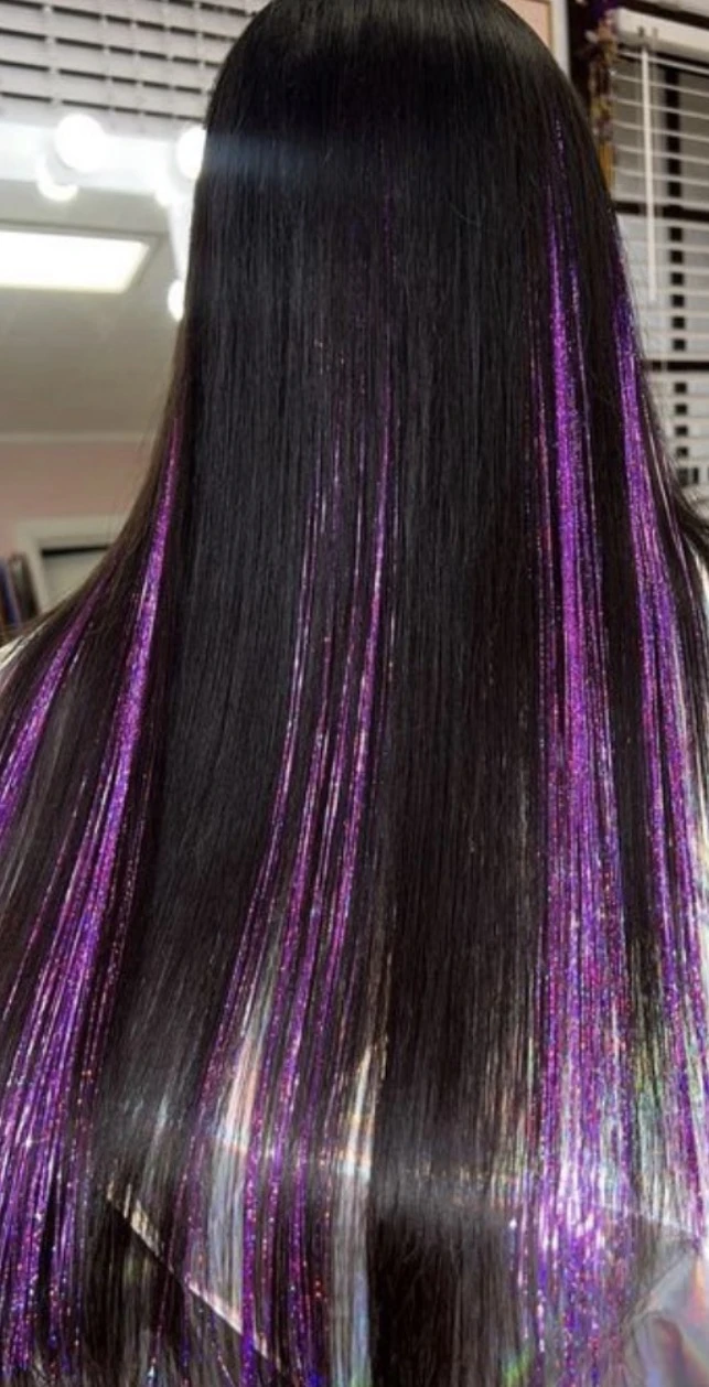 Purple tinsel through glossy black hair